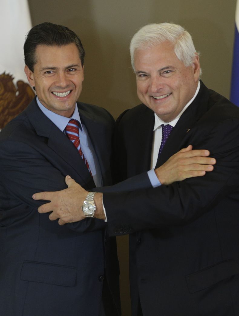 El presidente de M&eacute;xico Enrique Pe&ntilde;a Nieto, a la izquierda, y su par de Panam&aacute; Ricardo Martinelli se abrazan tras firmar un tratado de libre comercio en la Ciudad de Panam&aacute;, el jueves 3 de abril de 2014. (AP foto/Arnulfo Franco