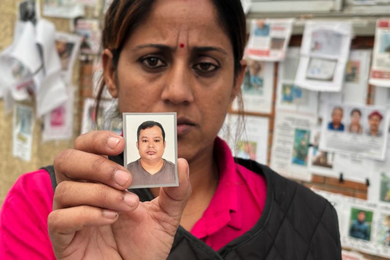 En esta imagen, tomada con un smartphone, Usha Khatri muestra una foto de su esposo, Indra Bahadur, desaparecido desde las inundaciones del mes pasado en el exterior del hospital universitario Tribhuvan, en Katmandú, Nepal, el 17 de septiembre de 2026. (AP Foto/Upendra Man Singh)