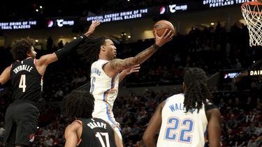 Jaylin Williams, derecha, del Thunder de Oklahoma City, se enfila a la canasta en contra de los Trail Blazers de Portland, dejando atrás a Matisse Thybulle, izquierda, durante la primera mitad del juego de baloncesto de la NBA, el domingo 19 de noviembre de 2023, en Portland, Oregon. (AP Foto/Steve Dykes)