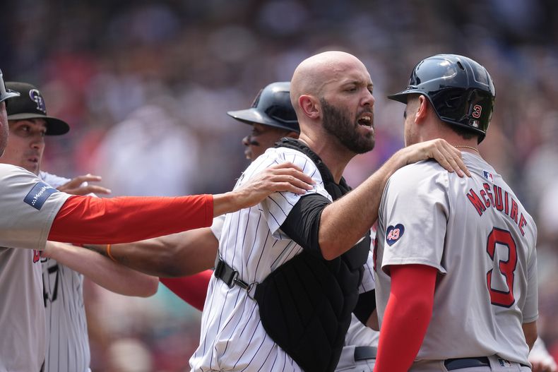 Jacob Stallings, receptor de los Rockies de Colorado, detiene a Reese McGuire, de los Medias Rojas de Boston, durante un altercado en el juego del miércoles 24 de julio de 2024 (AP Foto/David Zalubowski)