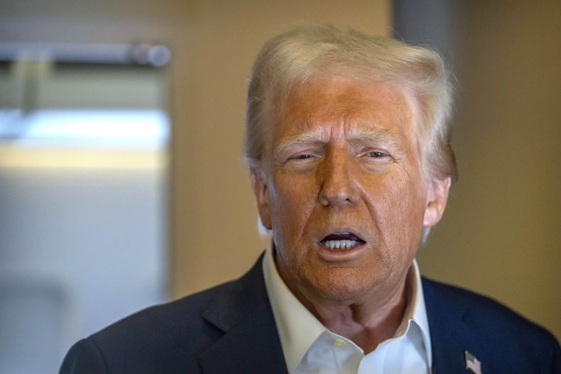 El presidente estadounidense Donald Trump habla con los reporteros a bordo del Air Force One en un viaje de Las Vegas a Miami, el sábado 25 de enero de 2025. (AP Foto/Mark Schiefelbein)