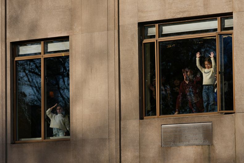 Espectadores observan desde las ventanas de sus apartamentos el desfile del Día de Acción de Gracias de Macys que pasa por Central Park West, el jueves 27 de noviembre de 2025, en Nueva York. (Foto AP/Frank Franklin)