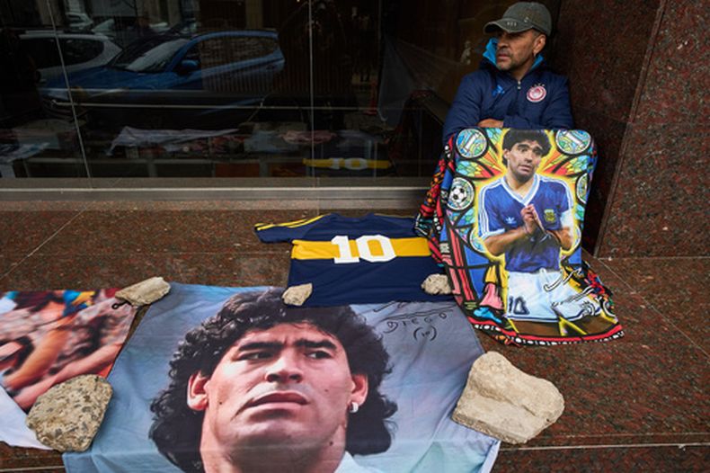 Un fanático de Diego Maradona sentado fuera del tribunal en donde se está llevando a cabo un juicio contra el equipo médico que trató a Maradona por presunto homicidio, en San Isidro, Buenos Aires, Argentina, miércoles Oct. 21, 2026. (AP Foto/Rodrigo Abd)