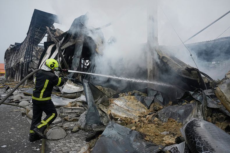 Los bomberos intentan extinguir un incendio tras un ataque de misiles en el centro de Kiev, el jueves 22 de octubre de 2026. (AP Foto/Efrem Lukatsky)