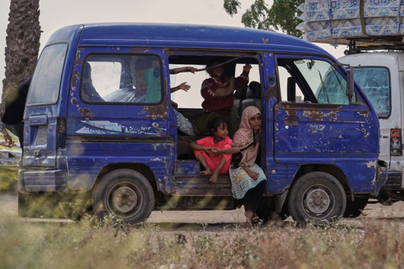 Niños yemeníes desplazados se ven en un vehículo mientras varias familias se reúnen para recibir ayuda en el campamento de desplazados Al-Fallahine en el distrito de Dar Saad, en Adén, Yemen, el lunes 12 de octubre de 2026. (AP Foto/Abdulnasser Alseddik)