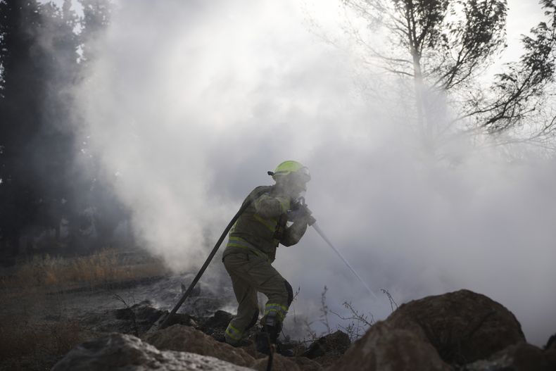 Un bombero israelí lucha contra las llamas en un incendio cerca de Latrun, Israel, a las afueras de Jerusalén, el 1 de mayo de 2025. (AP Foto/Ohad Zwigenberg)