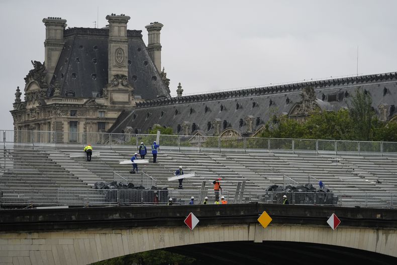 Trabajadores desmantelan las gradas en el Pony du Carrousel frente al museo del Louvre el sábado 27 de julio del 2024. (AP Foto/Rebecca Blackwell)