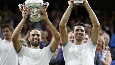 ARCHIVO - Los colombianos Juan Sebastián Cabal (izquierda) y Robert Farah levantan el trofeo de dobles de Wimbledon, el 13 de julio de 2019 (AP Foto/Kirsty Wigglesworth, archivo)