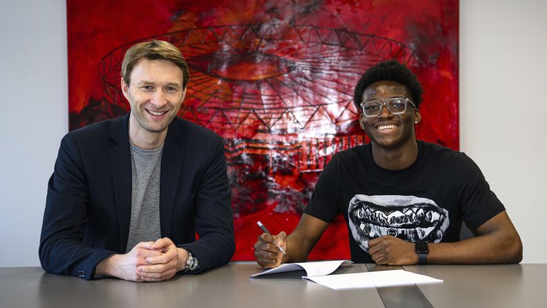 Simon Rolfes, izquieeda, director deportivo del Bayer Leverkusen, está sentado al lado de Axel Tape, joven defensa francés, después de firmar al jugador en una transferencia gratuita proveniente del Paris Saint-Germain, el miércoles 11 de junio de 2025, en Leverkusen, Alemania. (D. Mesch/Bayer Leverkusen vía AP)