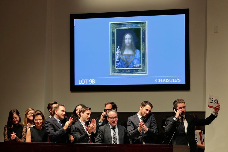 ARCHIVO - Representantes de una subasta reaccionan después de que Salvator Mundi de Leonardo da Vinci se vendiera por 450 millones de dólares en Christies en Nueva York, el 15 de noviembre de 2017. (Foto AP/Julie Jacobson, archivo)