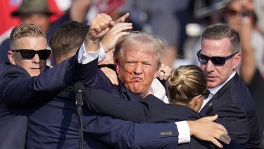 El candidato republicano a la presidencia Donald Trump alza el puño mientras recibe ayuda para salir del escenario en un acto de campaña en Butler, Pensilvania, el sábado 13 de julio de 2024. (AP Foto/Gene J. Puskar)