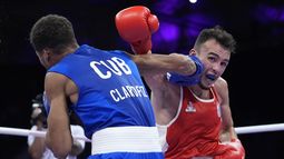 El francés Billal Bennama, de rojo, ante el cubano Alejandro Claro, en su combate de cuartos de final de peso mosca de los Juegos Olímpicos, el viernes 2 de agosto de 2024, en Villepinte, Francia. (AP Foto/Ariana Cubillos)