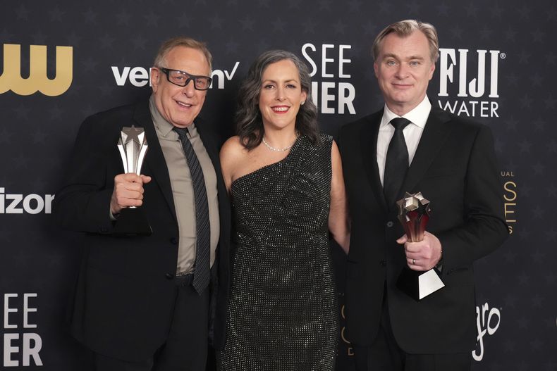 Charles Roven, de izquierda a derecha, Emma Thomas, y Christopher Nolan posan en la sala de prensa con el premio a la mejor película para Oppenheimer en la 29a edición de los Critics Choice Awards el domingo 14 de enero de 2024, en Barker Hangar en Santa Monica, California. (Foto Jordan Strauss/Invision/AP)