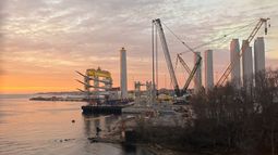 Hélices y bases de turbinas eólicas marinas se observan en una zona de estacionamiento en el muelle estatal de New London, Connecticut, el miércoles 14 de enero de 2026. (Foto AP/Matt OBrien)
