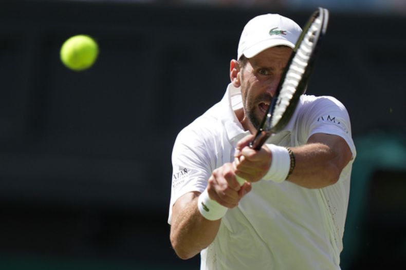 ARCHIVO - Novak Djokovic, de Serbia, regresa la pelota al ruso Roman Saffiullin en el juego de la rama varonil en la cuarta ronda del Campeonatro de Tenis de Wimbledon el 5 de julio de 2026. (AP Foto/Brian Inganga, Archivo)