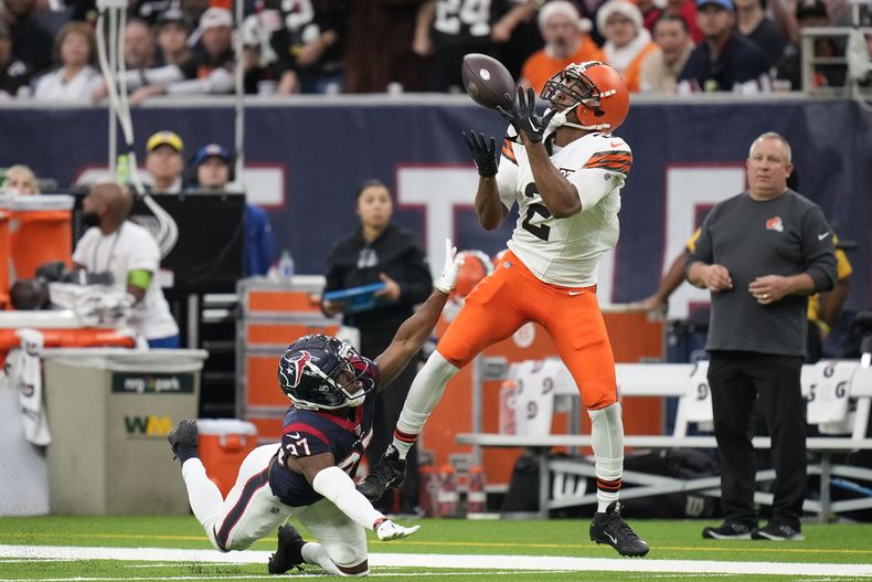 El wide receiver Amari Cooper (2), de los Browns de Cleveland, atrapa un pase de anotación mientras que DAngelo Ross (37), cornerback de los Texans de Houston, intenta evitarlo sin éxito, durante la primera mitad del juego de la NFL, el domingo 24 de diciembre de 2023, en Houston. (AP Foto/Eric Christian Smith)