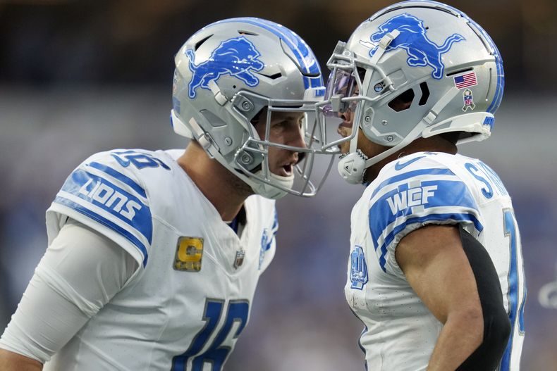 El wide receiver de los Detroit Lions Amon-Ra St.Brown (14) celebra su recepción de touchdown con el quarterback Jared Goff (16) durante la 2da mitad del juego de NFL ante los Chargers de Los Ángeles, el domingo 12 de noviembre de 2023, en Inglewood, California, EE.UU. (AP Foto/Ashley Landis)
