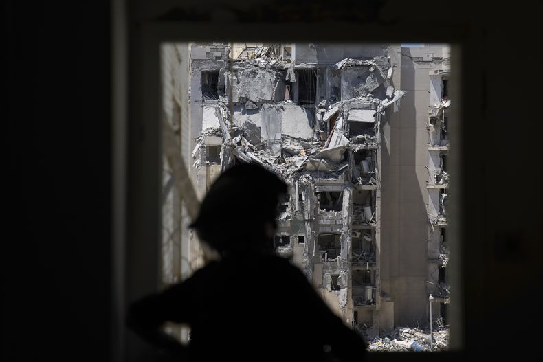 Un policía inspecciona un apartamento dañado al día siguiente de que un misil de Irán golpeara un edificio residencial, matando a varias personas, tras el anuncio de un cese el fuego, en Beersheba, Israel, el miércoles 25 de junio de 2025. (AP Foto/Ariel Schalit)