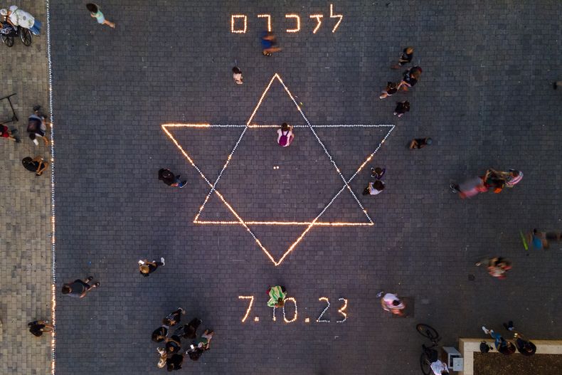 Israelíes encienden velas en recuerdo de las víctimas del sangriento asalto de Hamás al sur de Israel el 7 de octubre, en Raanana, Israel, el 7 de noviembre de 2023. (AP Foto/Ariel Schalit)