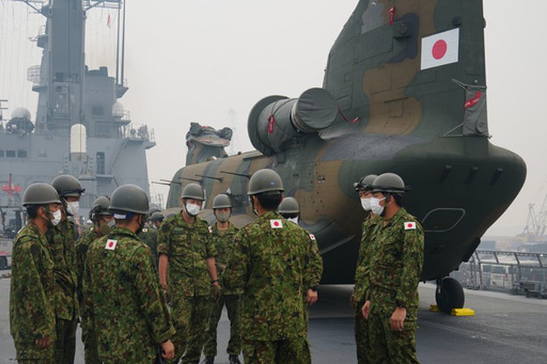 Efectivos japoneses participan en una reunión cerca de uno de los helicópteros Chinook que se utilizarán para ayudar a combatir incendios forestales en la isla de Kalimantan, en la cubierta del buque de desembarco JS Kunisaki tras su llegada al puerto de Kijing en Mempawah, en Kalimantan Occidental, Indonesia, el jueves 10 de septiembre de 2026. (AP Foto/Tatan Syuflana)