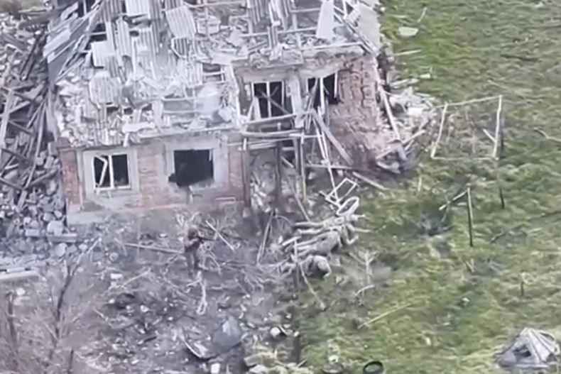Esta imagen tomada de un video que oficiales militares europeos afirman fue grabado por un dron ucraniano en la aldea de Piatykhatky, en el sur de Ucrania, el 13 de marzo de 2025, muestra a un soldado, izquierda, identificado como ruso, apuntando con su arma a cuatro soldados ucranianos tirados en el suelo que aparentemente se rindieron. (Ejército de Ucrania/Oficiales de Defensa Europeos vía AP)