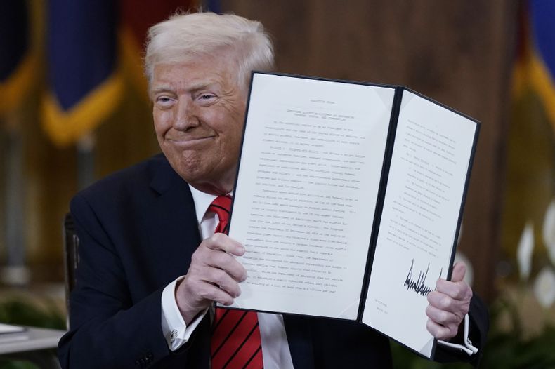 El presidente estadounidense Donald Trump sostiene una orden ejecutiva en la Sala Este de la Casa Blanca, en Washington, el jueves 20 de marzo de 2025. (AP Foto/Jose Luis Magana)