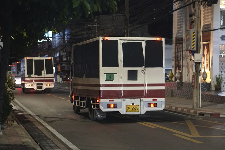 Esta foto proporcionada por el diario tailandés Prachatai muestra camiones con cinta negra cubriendo las ventanas saliendo de un centro de detención en Bangkok, Tailandia, el jueves 27 de febrero de 2025. (Nuttaphol Meksobhon/Prachatai vía AP)