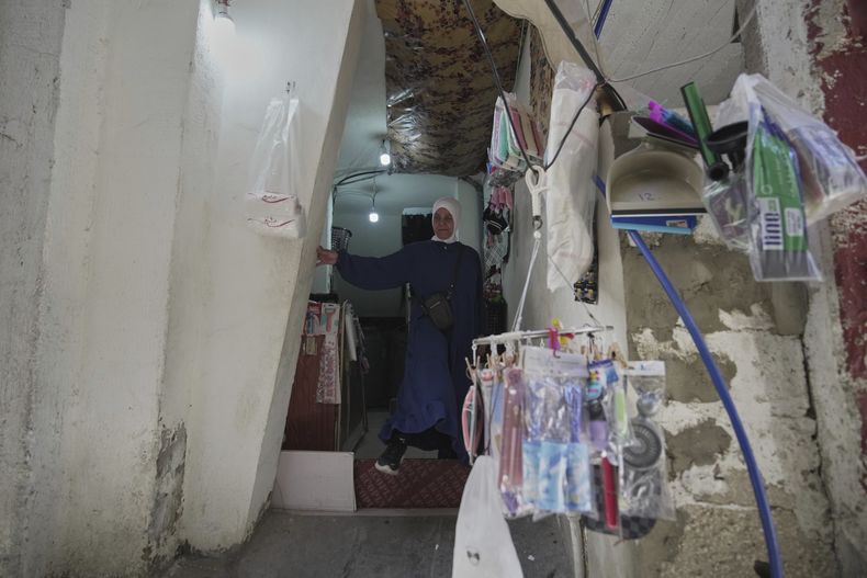 Ibtisam Salem, una refugiada palestina de 51 años madre soltera, en la entrada de su casa en el campo de refugiados de Mar Elias, en Beirut, Líbano, el 2 de junio de 2025. (AP Foto/Hassan Ammar)