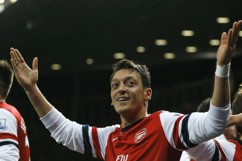 El delantero de Arsenal Mesut Ozil celebra su gol contra Everton en un partido de la Liga Premier en Londres el domingo 8 de diciembre del 2013. (AP Foto/Kirsty Wigglesworth)