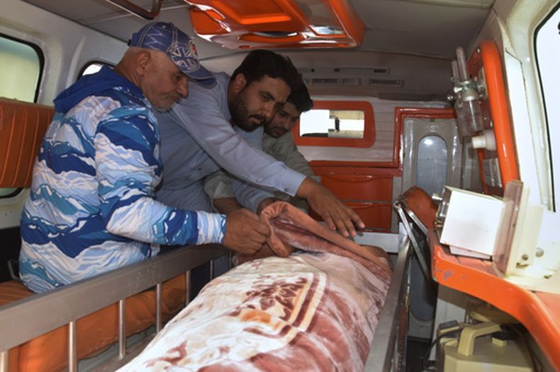 Un grupo de personas traslada el cuerpo de un juez de distrito que fue asesinado por presuntos milicianos que emboscaron su vehículo en una convulsa zona del suroeste, en Quetta, Pakistán, el jueves 23 de julio de 2026. (Foto AP/Arshad Butt)