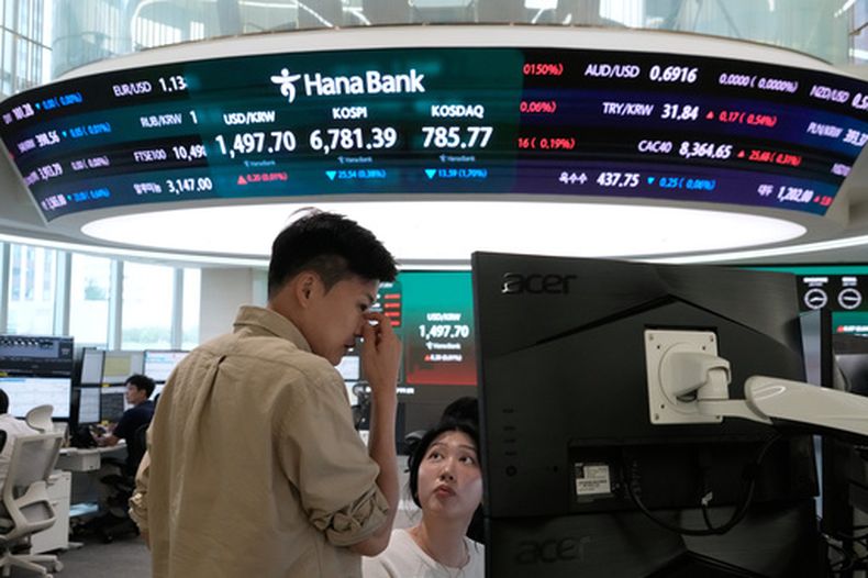 Operadores trabajan en la sala de divisas de la sede de Hana Bank en Seúl, Corea del Sur, el martes 14 de julio de 2026. (AP Foto/Ahn Young-joon)