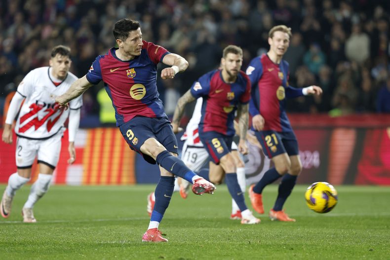 Robert Lewandowski anota de penal el gol del Barcelona en la victoria 1-0 ante el Rayo Vallecano en la Liga española, el lunes 17 de febrero de 2025. (AP Foto/Joan Monfort)