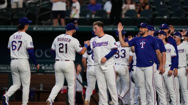 Jacob Latz (67), Jake Burger (21), Joc Pederson (centro), Nathan Eovaldi (derecha) y el resto de los Rangers de Texas tras su victoria sobre los Marineros de Seattle, el lunes 27 de julio de 2026, en Arlington, Texas. (AP Foto/Tony Gutiérrez)