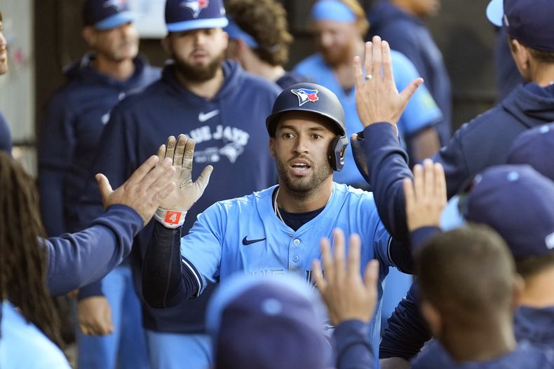 George Springer, de los Azulejos de Toronto, festeja en la cueva luego de anotar una carrera en el juego del martes 28 de mayo de 2024, ante los Medias Blancas de Chicago (AP Foto/Charles Rex Arbogast)