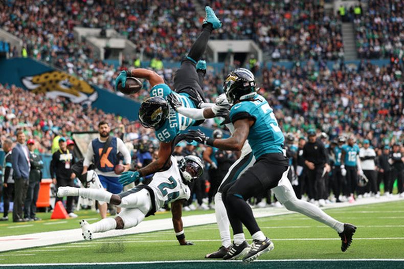 El tight end Brenton Strange (85) de los Jaguars de Jacksonville gira en el aire al quedarse corto de alcanzar la zona de anotación de los Eagles de Filadelfia, el domingo 11 de octubre de 2026. (AP Foto/Ian Walton)