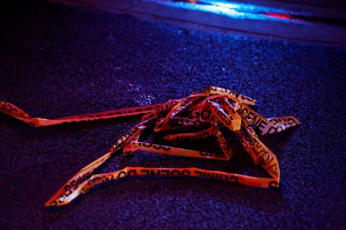 Discarded crime scene tape is seen on the ground hours after a gunman opened fire at a King Soopers grocery store in Boulder, Colorado, U.S. March 22, 2021. REUTERS/Kevin Mohatt