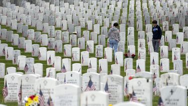 Personas caminan entre las lápidas mientras visitan la Sección 60 del Cementerio Nacional Arlington durante el Día de los Caídos en Guerras, el lunes 29 de mayo de 2023, en Arlington, Virginia. (AP Foto/Alex Brandon)