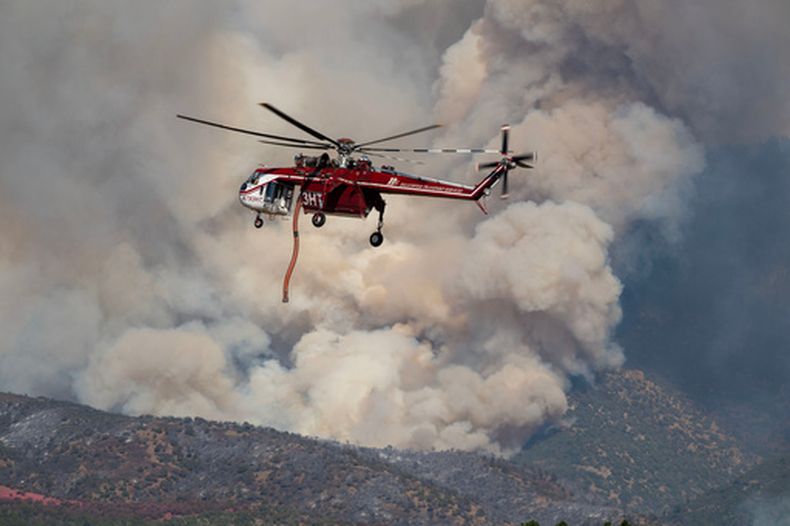 Un helicóptero Sikorsky Skycrane maniobra para reabastecerse durante las labores de extinción del incendio Widemouth 2, el martes 4 de agosto de 2026, al este de Fillmore, Utah. La aeronave se estrelló el viernes. (Scott G Winterton/The Deseret News vía AP)