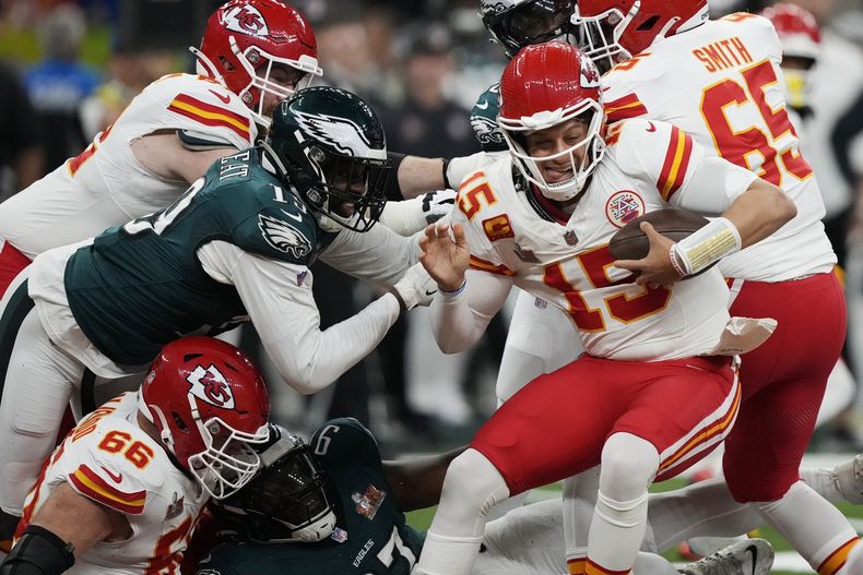 El quarterback de los Chiefs de Kansas City, Patrick Mahomes (15), intenta evitar el alcance del apoyador de los Eagles de Filadelfia, Josh Sweat, a la izquierda, durante la primera mitad del partido de fútbol americano del Super Bowl 59 de la NFL, el domingo 9 de febrero de 2025, en Nueva Orleans. (AP Foto/Brynn Anderson)