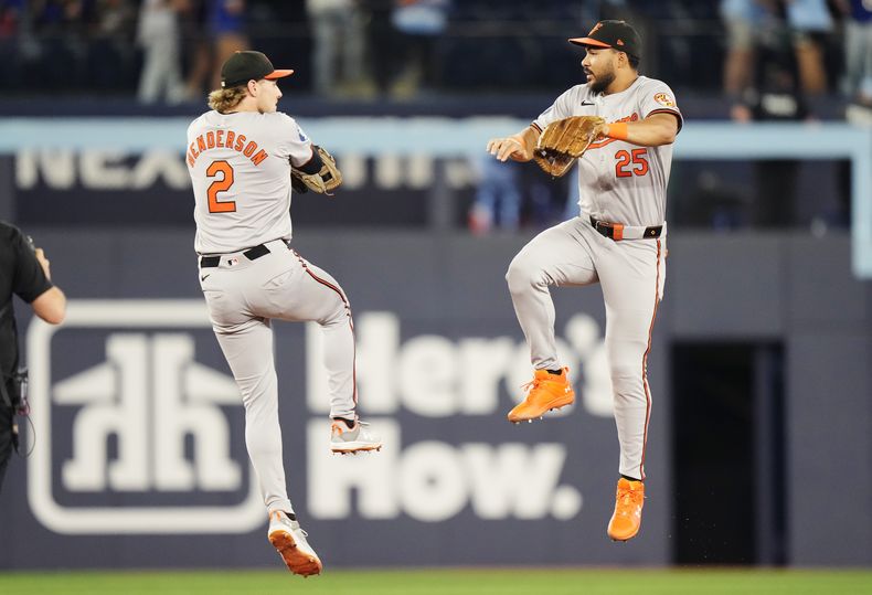 El campocorto de los Orioles de Baltimore Gunnar Henderson y el jardinero venezolano Anthony Santander celebran la victoria ante los Azulejos de Toronto el miércoles 7 de agosto del 2024. (Frank Gunn/The Canadian Press via AP)