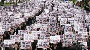 Profesores y personal de escuelas surcoreanas sostienen carteles durante una marcha para exigir mejores protecciones de sus derechos, cerca de la Asamblea Nacional en Seúl, Corea del Sur, el sábado 16 de septiembre de 2023. (AP Foto/Ahn Young-joon).
