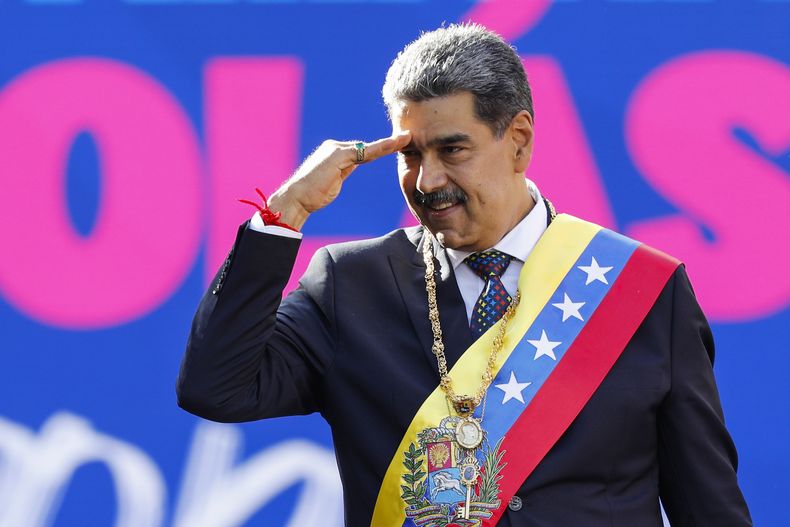 El presidente venezolano Nicolás Maduro saluda a sus partidarios el día de su toma de posesión para un tercer mandato en el palacio presidencial de Miraflores en Caracas, Venezuela, el 10 de enero de 2025. (AP Foto/Cristian Hernández)
