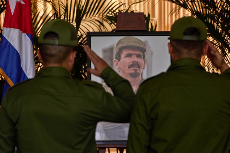 Personal militar saluda junto a una fotografía de Ramiro Valdés mientras rinde su último respeto a una de las últimas figuras prominentes de la Revolución Cubana, durante su funeral en La Habana, Cuba, el martes 23 de junio de 2026. (AP Foto/Ramón Espinosa)