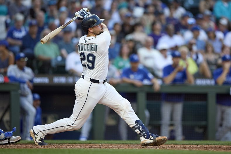 Cal Raleigh, de los Marineros de Seattle, sigue con la mirada el vuelo de un cuadrangular solitario frente al abridor Daniel Lynch IV, de los Reales de Kansas City, durante la séptima entrada del juego de béisbol de Grandes Ligas el lunes 30 de junio de 2025, en Seattle. (AP Foto/John Froschauer)