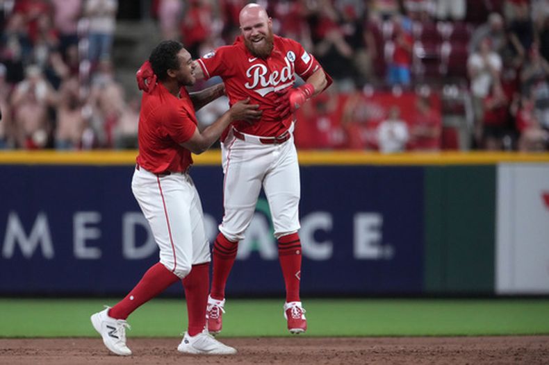Blake Dunn (centro), de los Rojos de Cincinnati, recibe la felicitación de Dane Myers, luego de batear un sencillo que puso fin al juego del martes 2 de junio de 2026 ante los Reales de Kansas City (AP Foto/Kareem Elgazzar)