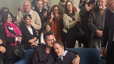 Rodrigo Salgado, hijo del fotógrafo y ambientalista brasileño Sebastiao Salgado, sentado en el centro, a la derecha, con el miembro de la familia Flavio Salgado, posan en una exhibición de Rodrigo, el sábado 24 de mayo de 2025, en Reims, Francia, un día después de la muerte del artista por leucemia, a los 81 años. (Sarah Heymann vía AP)