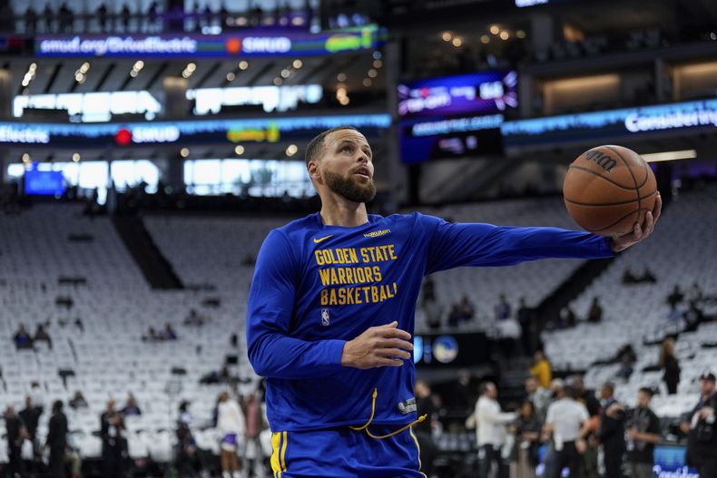 El escolta de los Warriors de Golden State, Stephen Curry, calienta para el partido del torneo de play-in de baloncesto de la NBA contra los Kings de Sacramento , el martes 16 de abril de 2024, en Sacramento, California (AP Foto/Godofredo A. Vásquez)