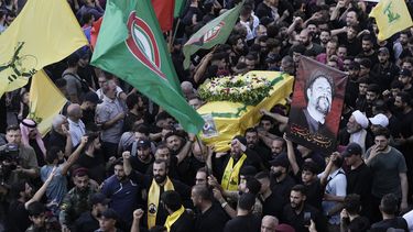 ARCHIVO - Combatientes de Hezbollah llevan uno de los ataúdes de cuatro compañeros caídos que murieron el martes después de que sus localizadores portátiles explotaran, durante su procesión fúnebre en el suburbio sur de Beirut, Líbano, miércoles 18 de septiembre de 2024. (AP foto/Bilal Hussein, archivo)