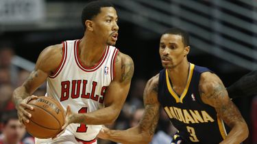 americateve | Derrick Rose, de los Bulls de Chicago, busca enviar un pase frente a George Hill, de los Pacers de Indiana, en el partido del s&aacute;bado 16 de noviembre de 2013 (AP Foto/Kamil Krzaczynski)