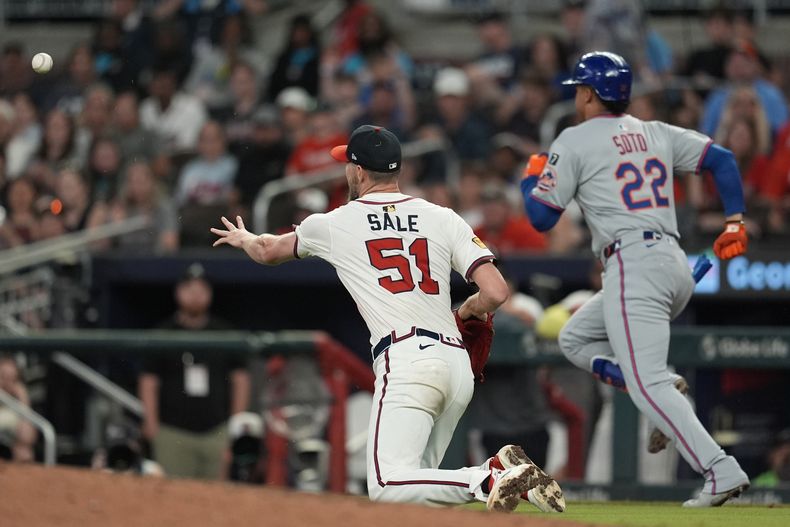 El lanzador Chris Sale (51) de los Bravos de Atlanta fildea una pelota bateada por Juan Soto (22) de los Mets de Nueva York en la novena entrada de un partido de béisbol, el miércoles 18 de junio de 2025, en Atlanta. (AP Foto/Mike Stewart)